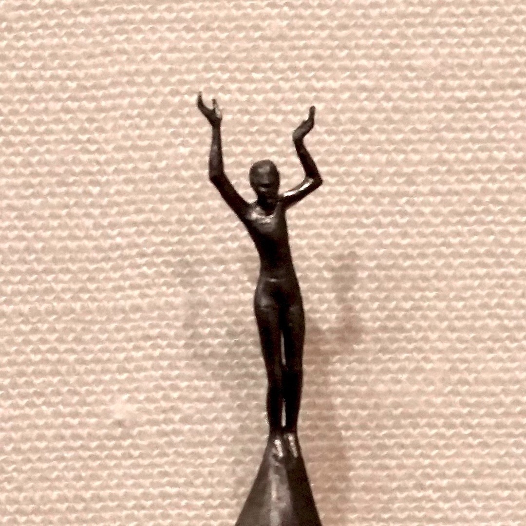 Picture of a sculpture of a dancer carved. The sculpture is carved out of the leaded point of a standard pencil. The carved sculpture fills the frame.